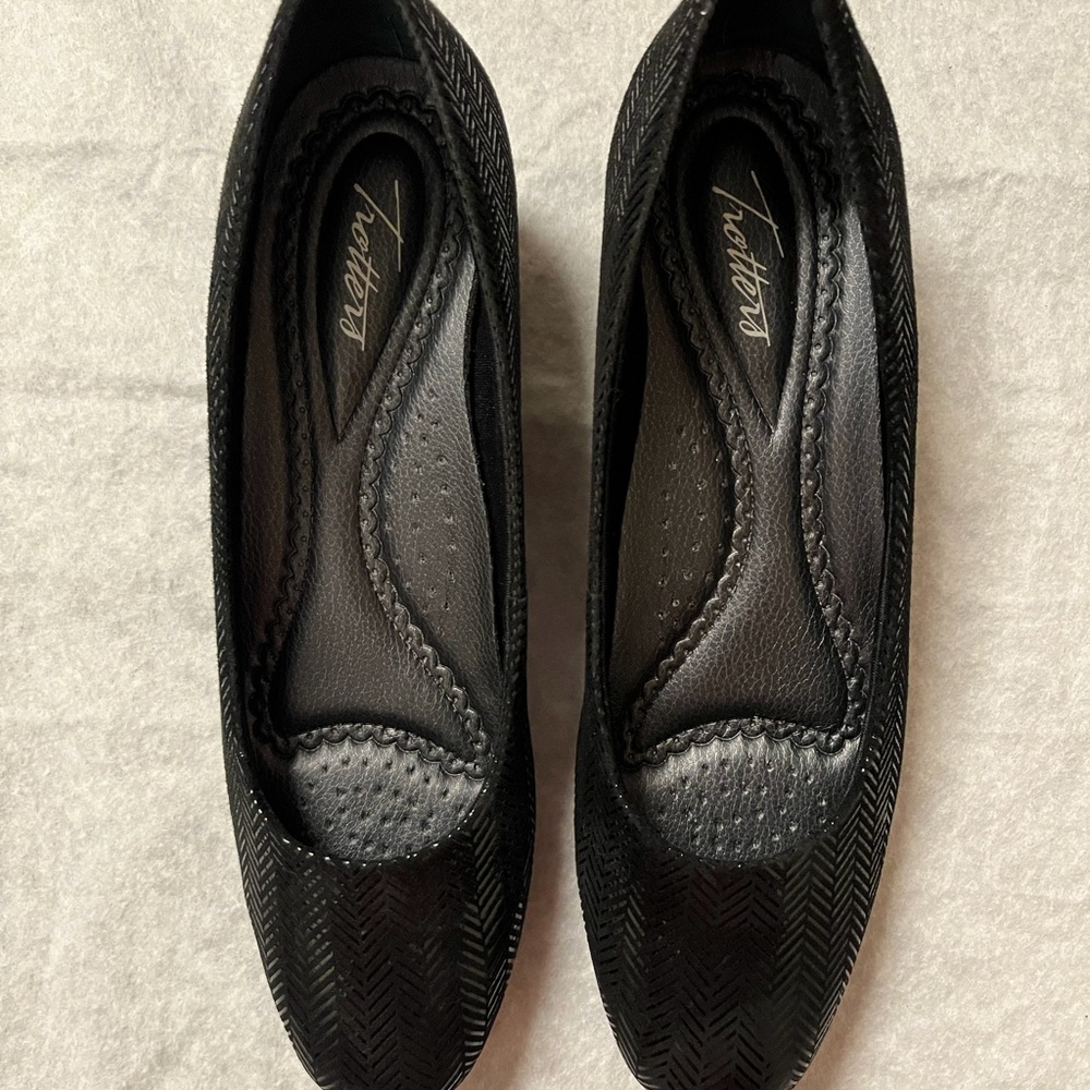 Black dress shoe with wedge heel.